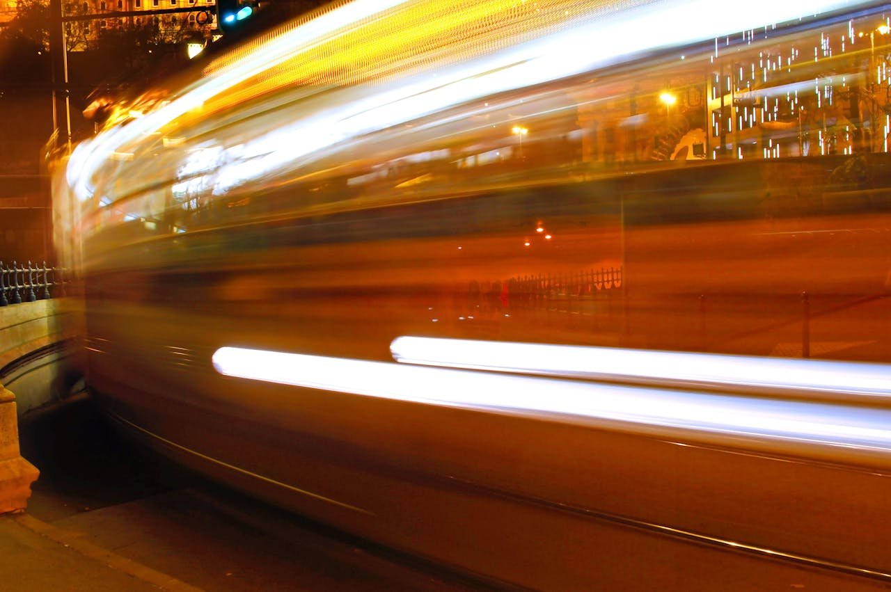 why-choose-us Stunning long exposure capturing blurred motion of a city street at night, creating vibrant light trails.