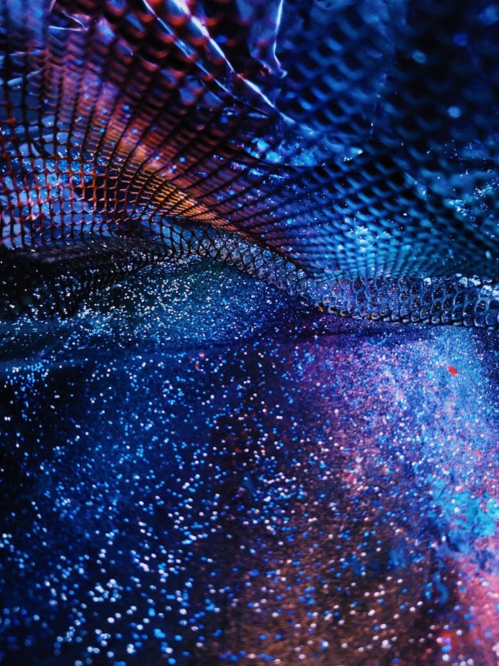 our-services-1 A mesmerizing abstract image featuring colorful shimmering glitter under a cosmic pattern, evoking mystery and elegance.