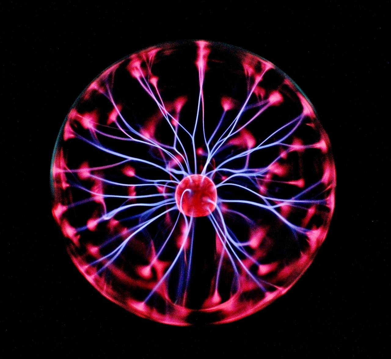 hero-img-01 Close-up of a plasma globe with vibrant neon sparks against a dark background.
